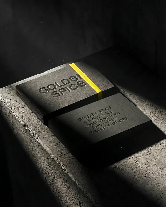 Illustrative mockup: dark business cards with a yellow edge